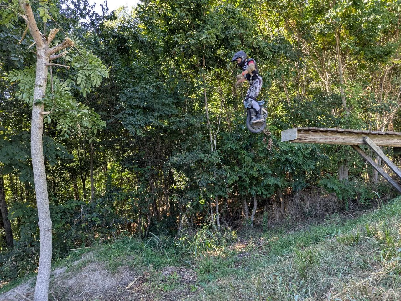 Bradley Moles riding a KingSong F18 off a jump at Camp Shred