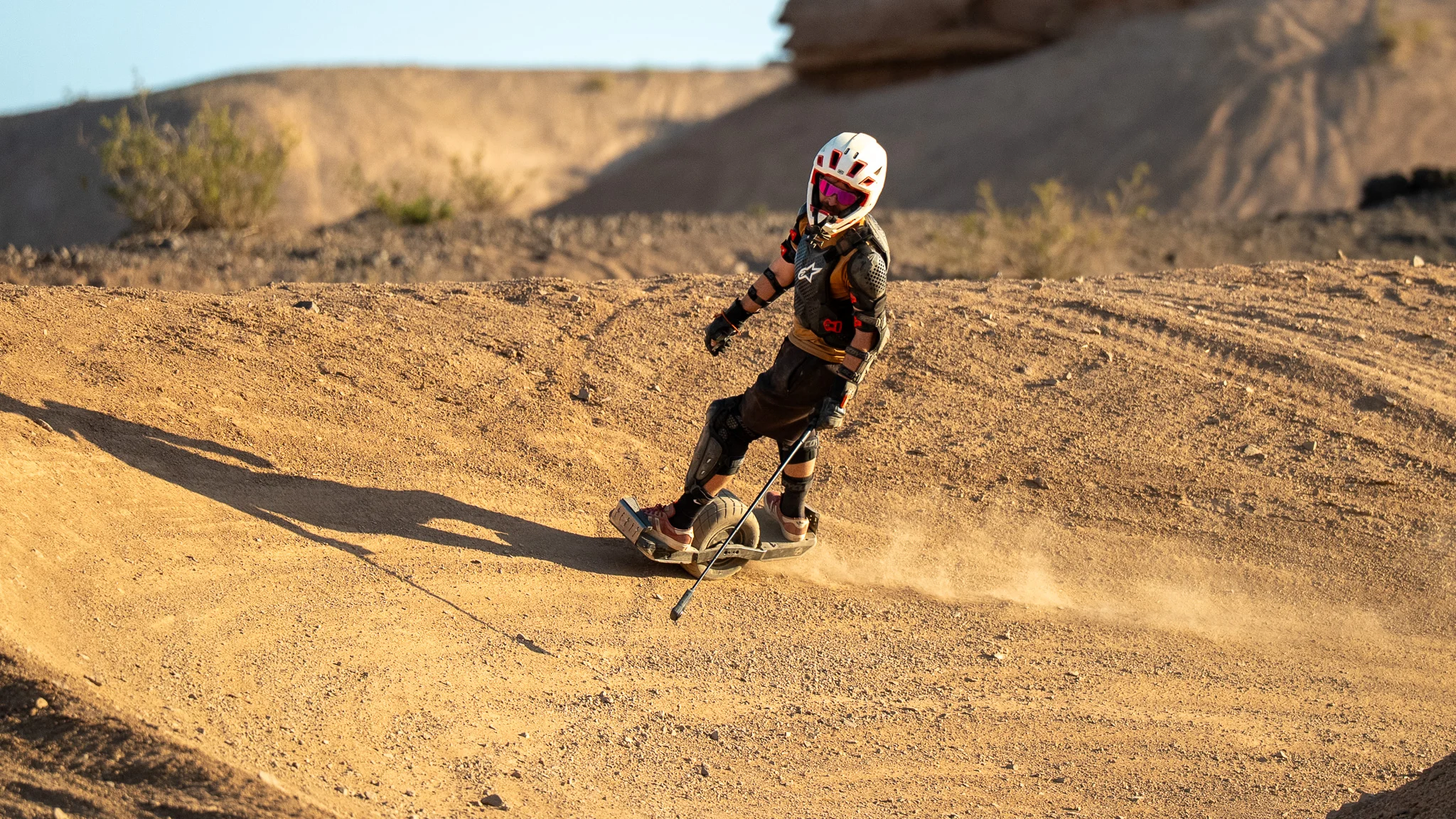 Cameron Patecell carving a sandy desert berm on a Onewheel at Let It Ride 5
