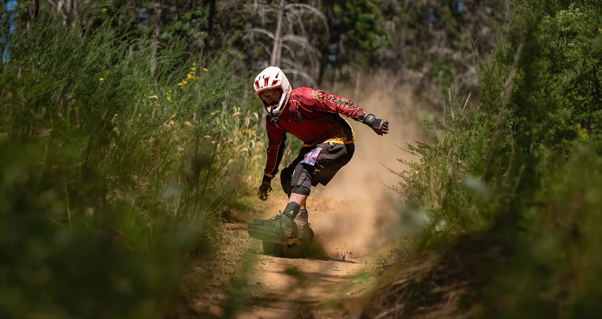 Cameron Patecell riding a Fungineers-equipped Onewheel on trail.